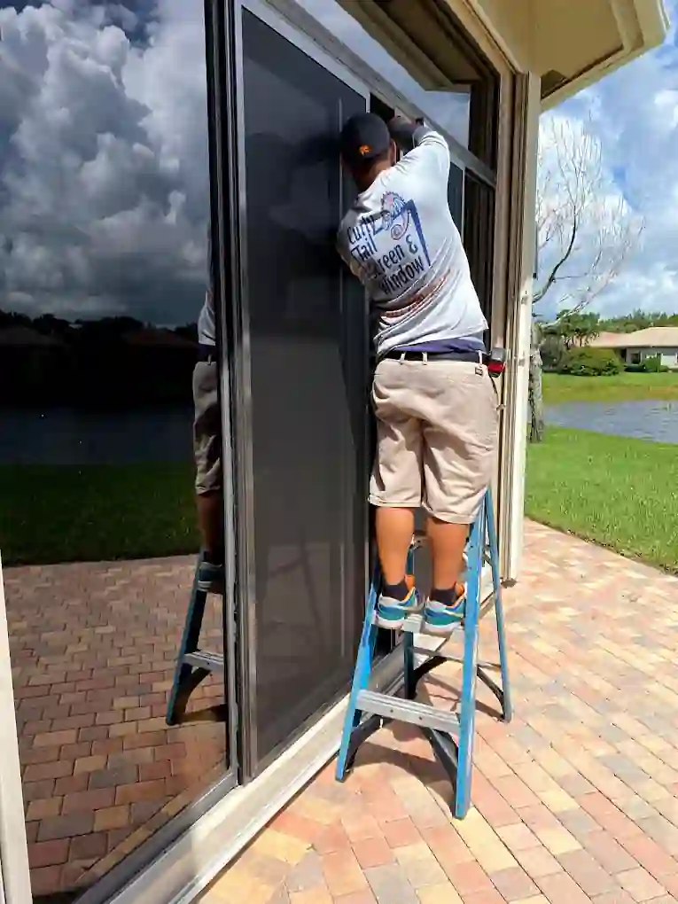 Sean installing a screen door